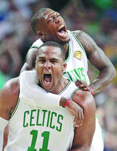Boston’s Glen Davis, front, and Nate Robinson celebrate a fourth-quarter scoring run against the Lakers.  (Associated Press)