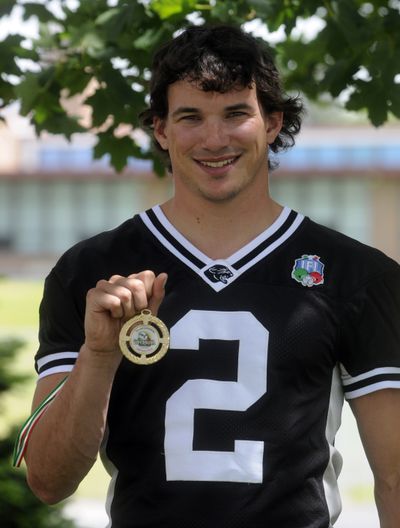 Former EWU and West Valley High School standout wide receiver Craig McIntyre shows a medal he won in Italy, where his football team won the Italian Super Bowl.  (J. BART RAYNIAK)
