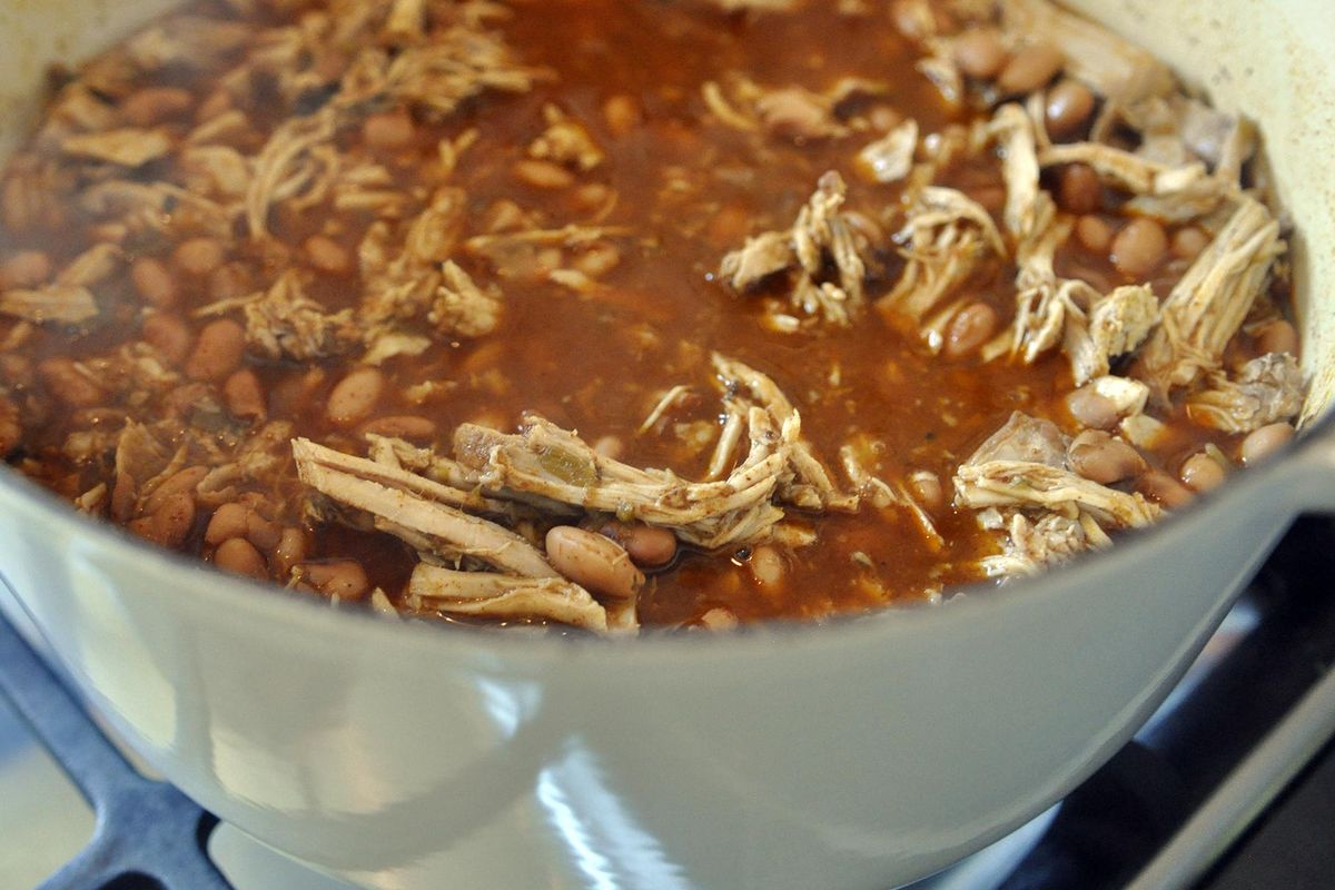 After it’s shredded, the pork loin for Rachel Hamby’s chalupa is returned to the stove top for another hour of cooking. It cooks for six hours in all. (Adriana Janovich / The Spokesman-Review)