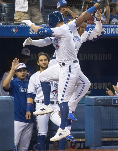 Toronto Blue Jays’ Randall Grichuk, front, and Vladimir Guerrero Jr. celebrate after hitting back-to-back home runs against the Seattle Mariners during the third inning Friday, Aug. 16, 2019, in Toronto. (Fred Thornhill / Canadian Press)