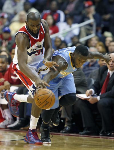 Wizards forward Chris Singleton, left, and Nuggets guard Nate Robinson, right, race to track down a loose ball in the second half. (Associated Press)