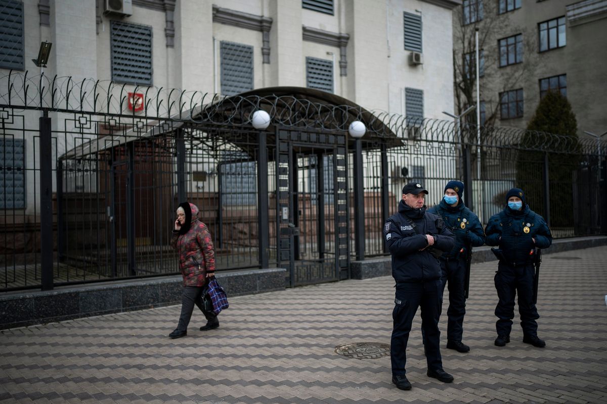 Ukrainian police officers stand guard in front of the Russian Embassy in Kyiv, Ukraine, Wednesday, Feb. 23, 2022. Ukraine urged its citizens to leave Russia as Europe braced for further confrontation Wednesday after Russia