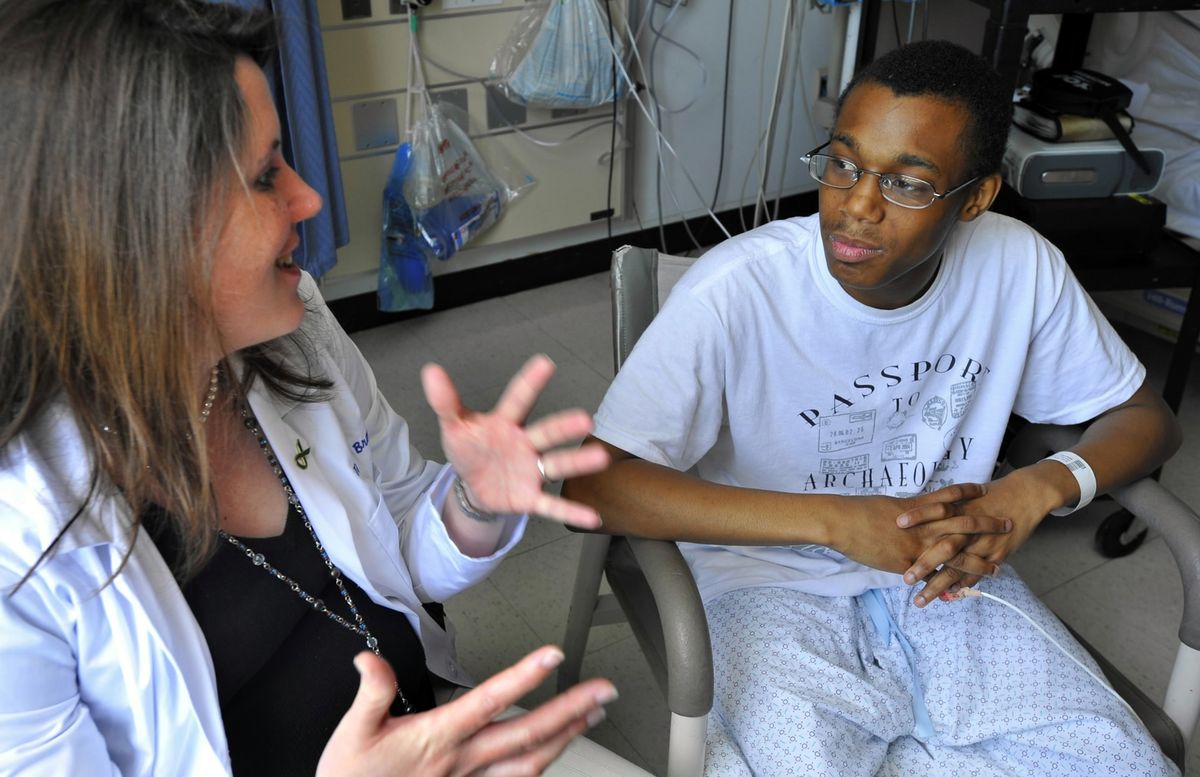 Dr. Tammy Brady, a pediatric nephrologist, talks with Va’Sean Duvall at Johns Hopkins Children’s Center. Research at Johns Hopkins indicates that hypertension puts young people at greater risk for severe heart problems when they grow older. (Amy Davis / The Spokesman-Review)