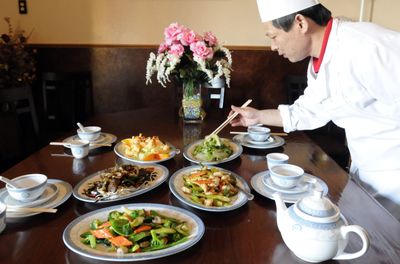 Chef Raymond Kong of China Garden restaurant on the South Hill prepared several dishes typical of a Chinese New Year celebration last week. The dishes are, clockwise from the bottom, garden delight, Mongolian beef, honey walnut prawns, cooked lettuce and asparagus chicken.  (Jesse Tinsley / The Spokesman-Review)