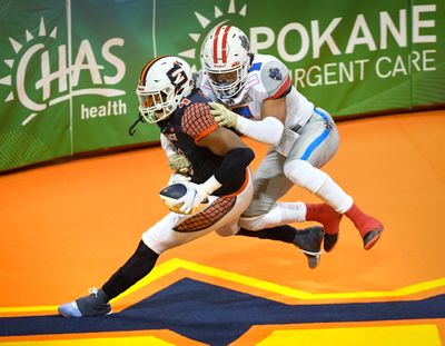 Spokane Shock WR Jordan Jolly (4) hauls in a pass for a touchdown over Northern Arizona Wranglers DB Kalen Hicks (6) in the first quarter, Saturday, June 19, 2021, in the Spokane Arena.  (DAN PELLE/THE SPOKESMAN-REVIEW)