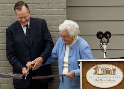 
Former President George H.W. Bush and former first lady Barbara Bush cut the ribbon Tuesday during the dedicationof the childhood home of President George W. Bush in Midland, Texas.
 (Associated Press / The Spokesman-Review)