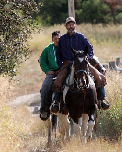 
Rex Rammell, right, and son Jake  search for escaped elk in September. 
 (File Associated Press / The Spokesman-Review)