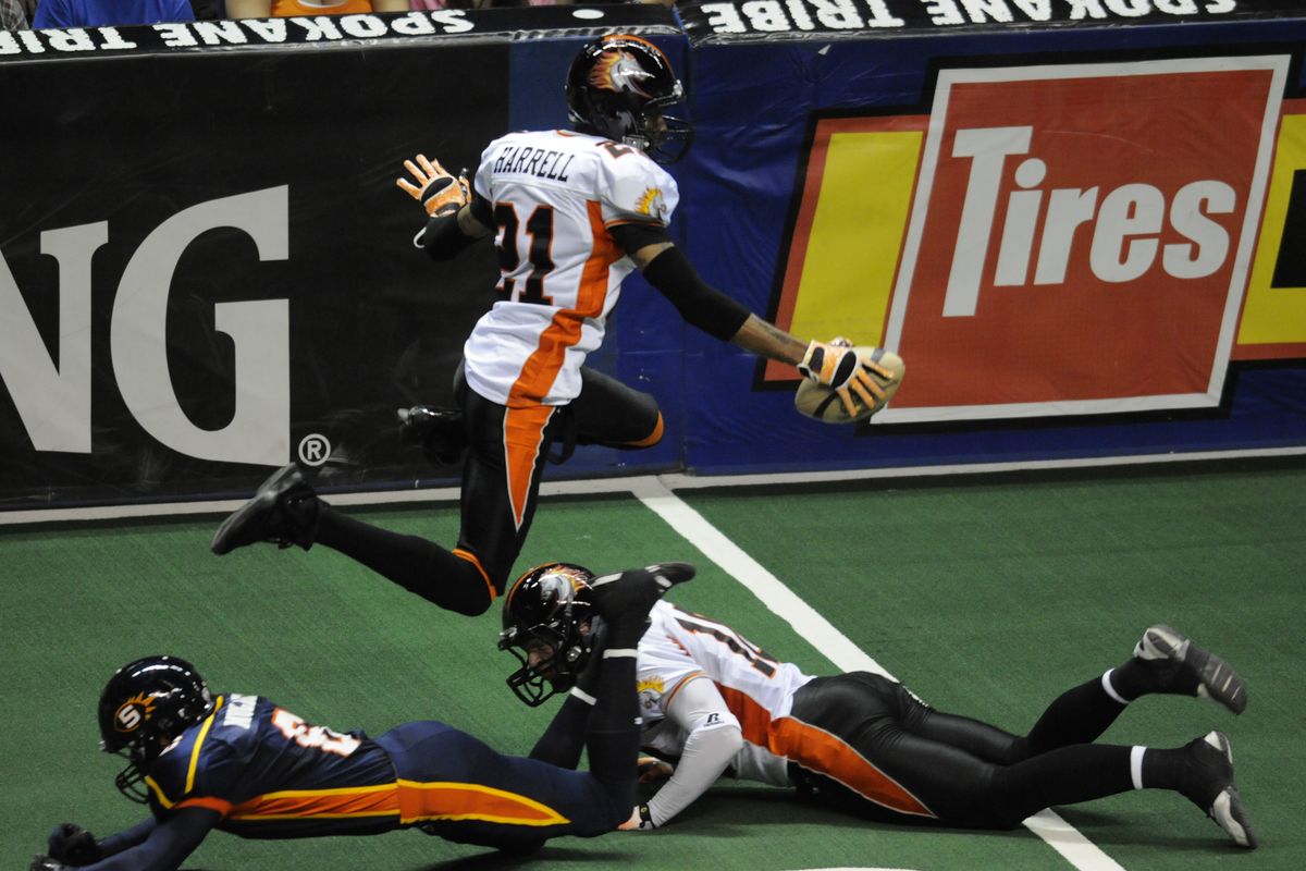 After a reception, Milwaukee’s Damian Harrell hurdles William Mulder of the Shock. (Colin Mulvany)