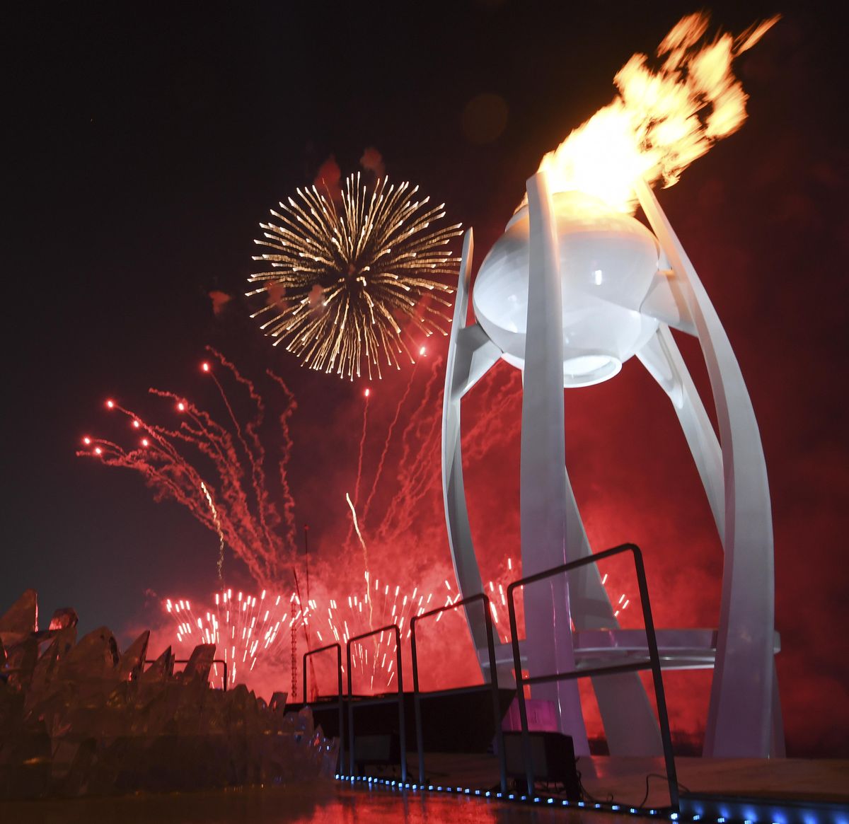 Fireworks explode behind the Olympic flame during the opening ceremony of the 2018 Winter Olympics in Pyeongchang, South Korea, Friday, Feb. 9, 2018. (Franck Fife/Pool Photo via AP) ORG XMIT: OLYJL154 (Franck Fife / AP)