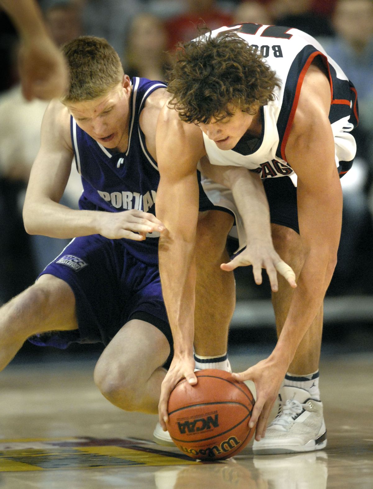 The Spokesman-Review GU guard Matt Bouldin, right, grabs a loose ball in front of Portland’s Ethan Niedermeyer during last year’s game in Spokane. (File / The Spokesman-Review)
