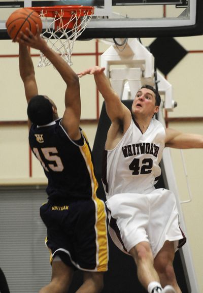 Whitworth’s Jack Loofburrow thwarts a dunk attempt by Whitman’s David Michaels on Tuesday. (Dan Pelle / The Spokesman-Review)