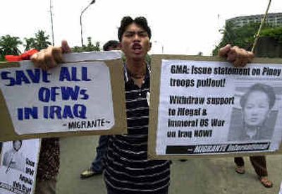 
A supporter of Angelo dela Cruz, the Filipino truck driver held hostage in Iraq, shouts slogans during a rally Friday in front of the Department of Foreign Affairs in Manila. 
 (Associated Press / The Spokesman-Review)