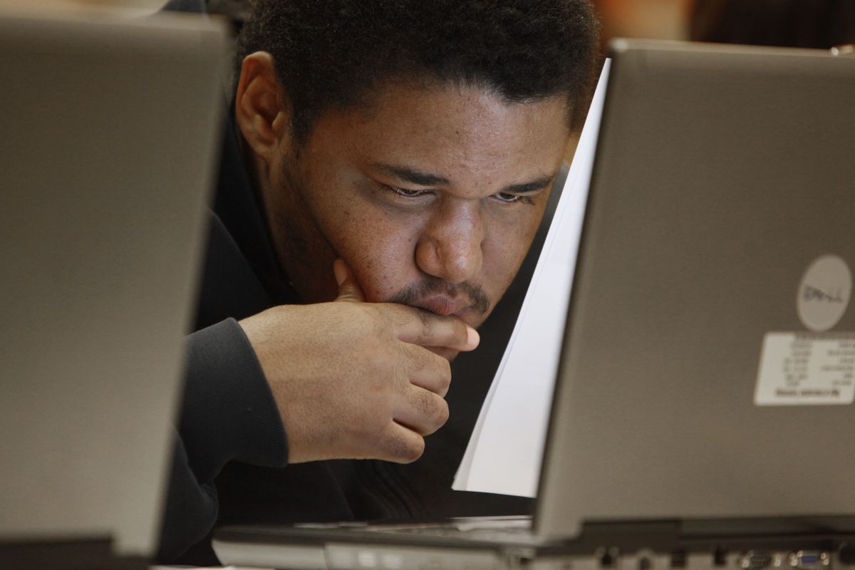  Job seeker Talib Hasan checks online for openings at a job fair in Livonia, Mich., on Nov. 10. (Associated Press)