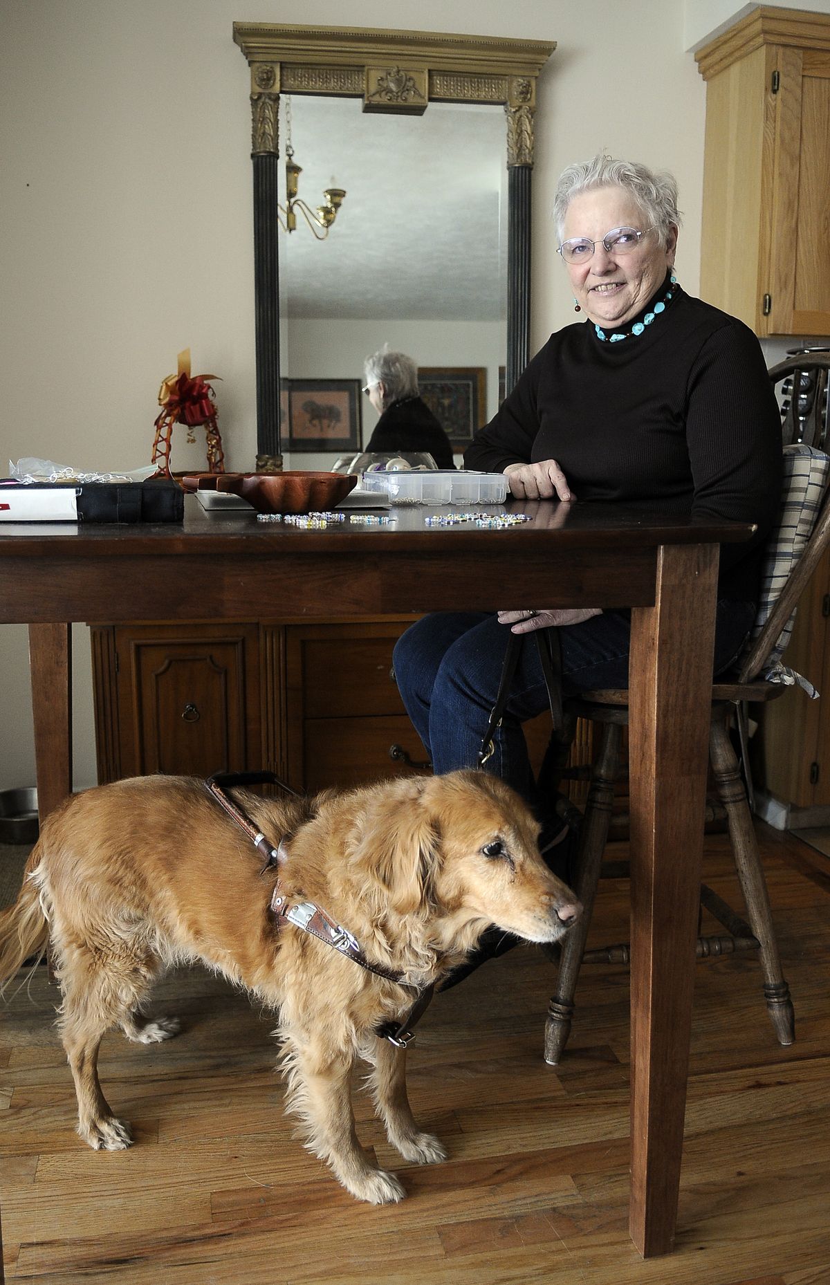 Katharine Surette, 69, makes jewelry in her home workshop near Sacred Heart Medical Center in Spokane. Surette, who is blind, uses a service dog named Julie.  (Dan Pelle / The Spokesman-Review)