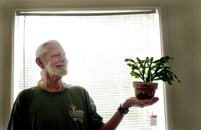 Jerry Horton shows off one of his plants at his apartment in Coeur d’Alene on  July 9. When he moved into his own place with the help of a Coeur d’Alene outreach program, he was granted a special wish:  houseplants to add life to his new apartment. (Kathy Plonka / The Spokesman-Review)