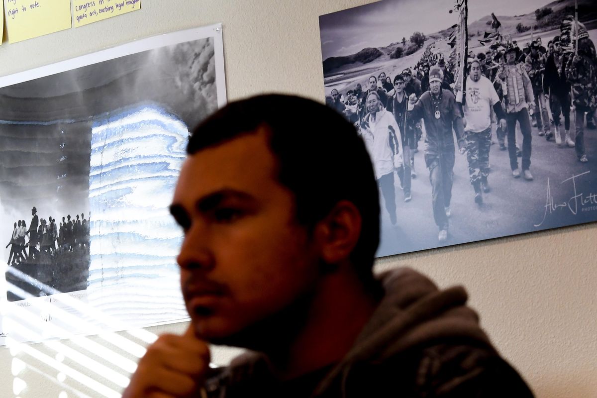 Xephen Bailey-Arnett, a sophomore at Wellpinit High School, listens during a sign language class on Thursday, Nov. 21, 2019. Behind him hangs a photo from the Standing Rock protests made by photographer Alex Flett, who graduated from Wellpinit High. November is Native American Heritage Month. (Tyler Tjomsland / The Spokesman-Review)