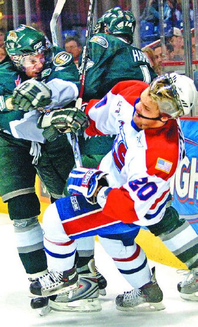 
Everett's Jesse Zetariuk, left, smacks Spokane's David Rutherford during Tuesday's playoff game. 
 (Holly Pickett / The Spokesman-Review)