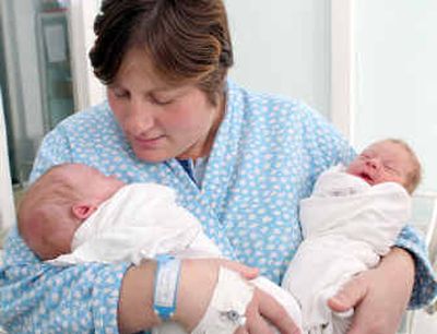 Maricica Tescu holds her twin sons Valentin, left, born Monday, and Catalin, who was born in December, at a hospital Tuesday in Iasi, northern Romania.
 (Associated Press / The Spokesman-Review)