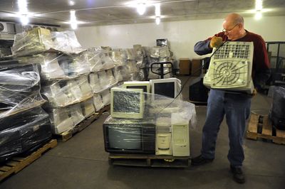 Greg Wheeldon, who works for Goodwill Industries, sorts through used computer monitors and televisions as he readies the electronics for recycling Tuesday at the Goodwill warehouse at Trent Avenue and Hamilton Street in Spokane. The organization designated its Spokane locations as e-waste collection points.  (Dan Pelle / The Spokesman-Review)