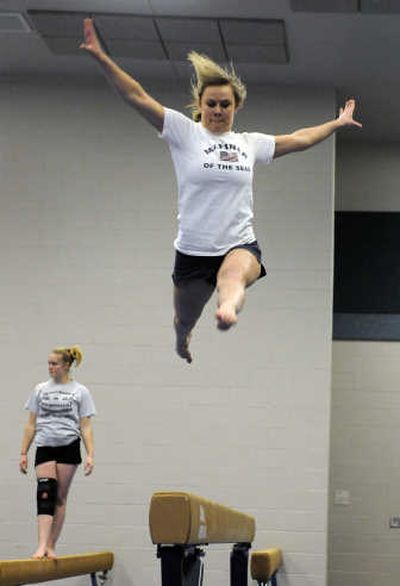 
Courtney Sexton, a senior at Central Valley High School, works high above the balance beam during practice Jan. 24. 
 (Dan Pelle / The Spokesman-Review)