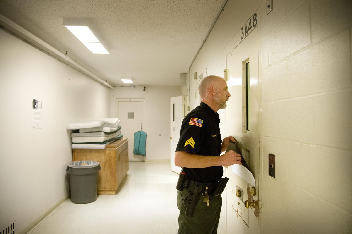 Sgt. Don Hooper listens to complaints last year from a holding cell near the room where Spokane County Jail inmates appear in court via a video link. Spokane County may hire three more detention officers and accept more federal detainees to boost revenues. (Jesse Tinsley / The Spokesman-Review)