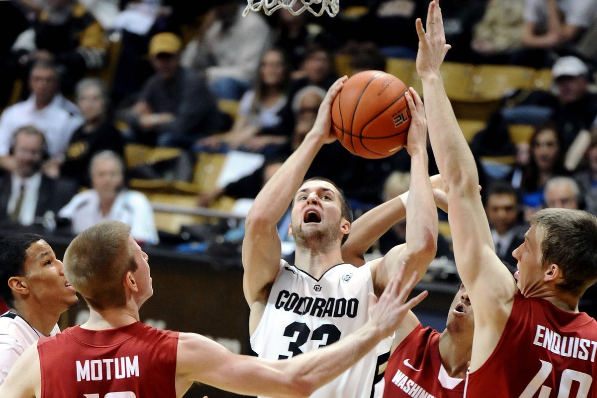 Colorado’s Sabatino Chen pulls down a rebound while surrounded by Brock Motum, left, and Charlie Enquist. (Associated Press)