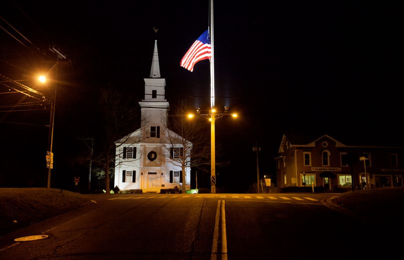 FILE - A U.S. flag flies at half-staff on Main Street in Newtown, Conn. on Saturday, Dec. 15, 2012 in honor of those killed when a gunman opened fire inside the town's Sandy Hook elementary school. In just a four-month span, New England has been the backdrop for two incidents of mass carnage - the Dec. 14, 2012 shootings in Newtown, that killed 20 children and six staff members at the school, and the Boston Marathon bombings on April 15, 2013 that killed three people and injured more than 260. (David Goldman / Associated Press)