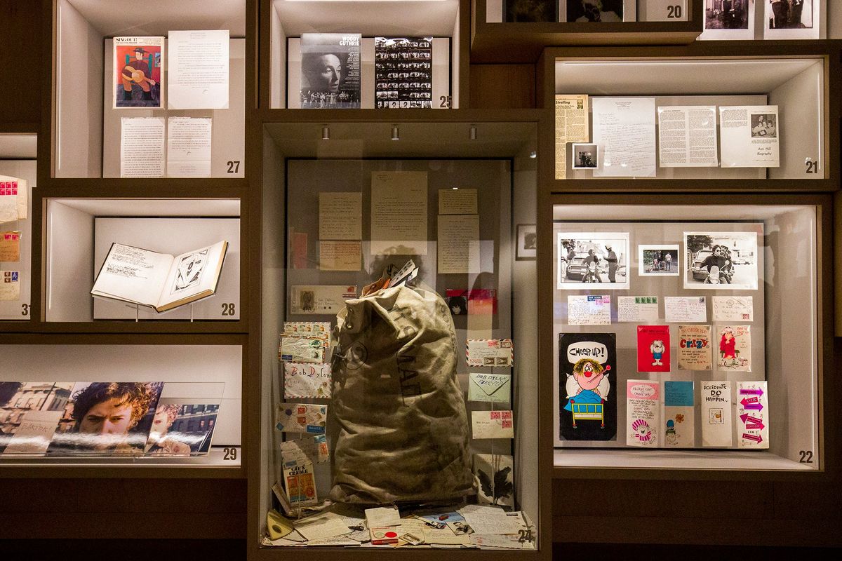A wall of archive items at the Bob Dylan Center in Tulsa, Okla., contains, among other things, the bag that was found full of unopened mail from fans.  (Shane Bevel/For the Washington Post)