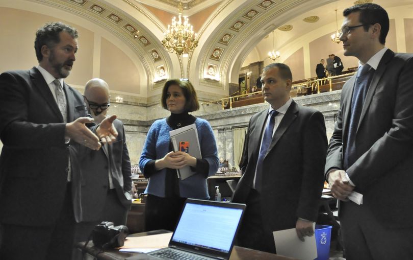 OLYMPIA – Sen. Kevin Ranker, far left, tries to make a point to Sen. Joe Fain, R-Auburn, as Sens. John Braun and Christina Rolfes and Senate Democratic spokesman Aaron Wasser look on. Some senators engaged in a contentious debate over school funding measures at the press table on March 6 even though the Senate had adjourned for the day. (Jim Camden / The Spokesman-Review)