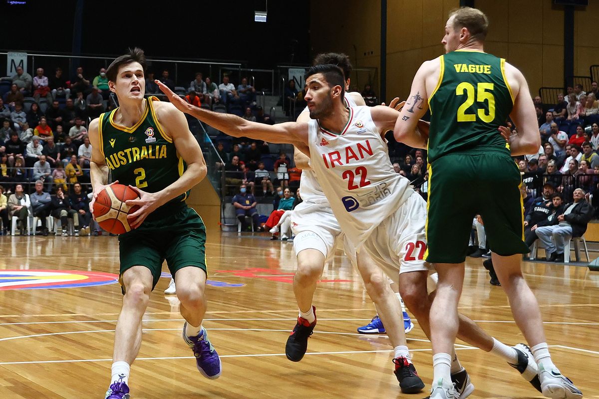 Alex Toohey, left, looks to pass during the FIBA World Cup 2023 Asian Qualifier match between the Australia Boomers and Iran at Red Energy Arena on August 29, 2022 in Bendigo, Australia.  (Getty Images)