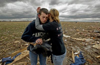 
Katlyn Kendall tries to console Chris Longdon, 17, in a flattened cornfield Monday near Renick, Mo.  A tornado destroyed the trailer Longdon shared with his girlfriend and her parents. The parents were killed and his girlfriend broke her back. 
 (Associated Press / The Spokesman-Review)