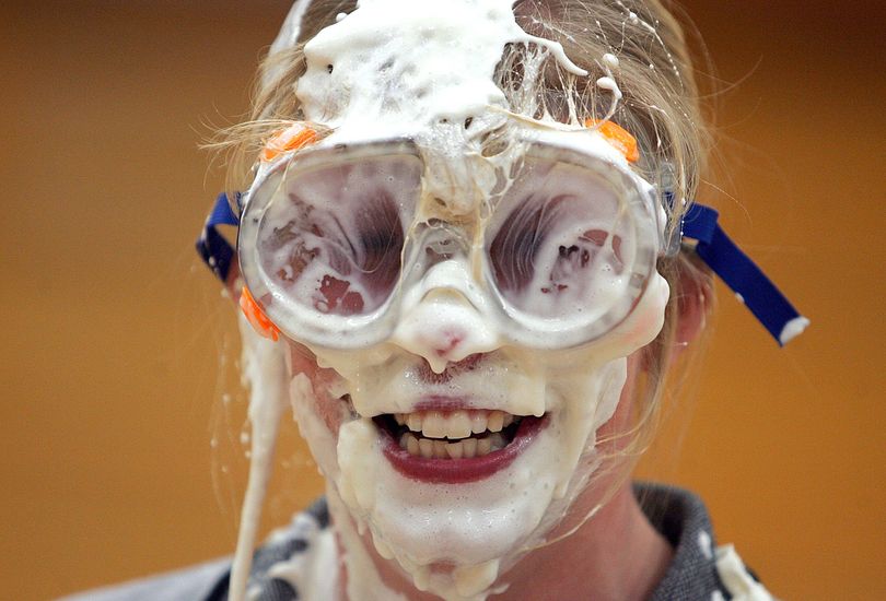 In this photo taken Thursday, Feb. 25, 2010, Cuba City High School teacher Stacy Balbach reacts after getting hit in the face with a whipped cream pie during a pep rally at the school in Cuba City, Wis. Students came up with the idea of tossing pies to raise money for the relief effort in Haiti, after a devastating 7.0 earthquake rocked the country last month. Over $700 was raised. (Jeremy Portje / Telegraph Herald)