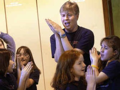 
PRO Team adviser and Progress Elementary teacher Jeff Wallingford leads his charges through a song and dance Wednesday afternoon at the West Central Community Center. The group of elementary students recently won the Chase Youth Award for Community Service. 
 (Brian Plonka / The Spokesman-Review)