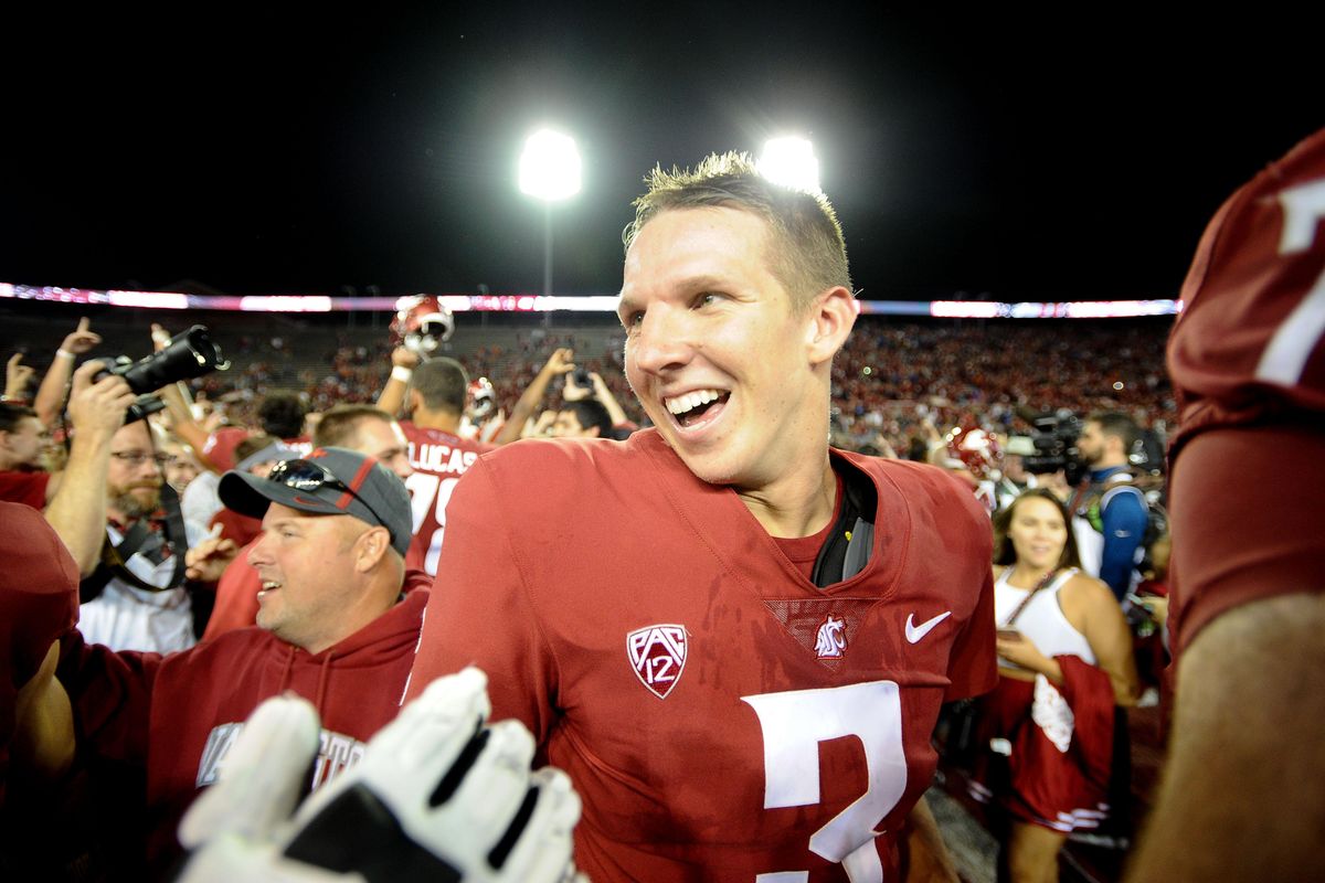 In this Sept. 9, 2017 file photo, Washington State Cougars quarterback Tyler Hilinski (3) is mobbed by teammates after WSU defeated Boise State in triple overtime on at Martin Stadium in Pullman, Wash. (Tyler Tjomsland / The Spokesman-Review)