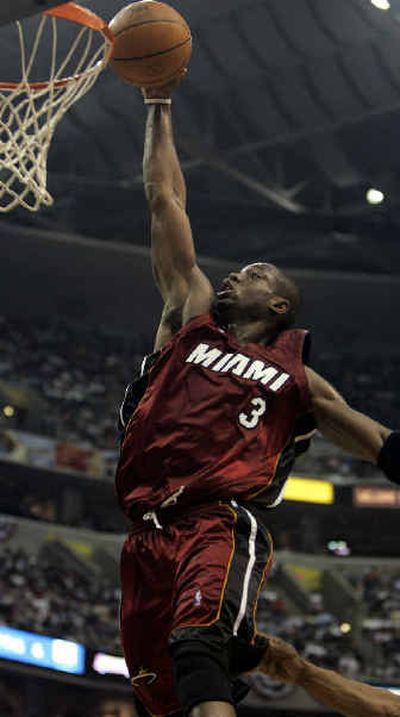 
Miami's Dwyane Wade scores two of the 22 points he totaled in the third quarter of Saturday's win over Washington. 
 (Associated Press / The Spokesman-Review)