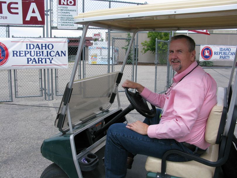 Legislative candidate Mike Kingsley drives a cart to give Idaho GOP convention attendees rides between the parking lot and the Ford Idaho Center in Nampa (Betsy Z. Russell)