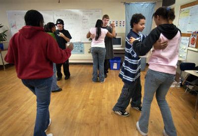 
Shaw Middle School students work on their salsa dance moves Wednesday morning in teacher Rhonda Clark's classroom at Shaw Middle School in Spokane.  Clark, a former ballroom dancing competitor, spends thirty minutes before school, two days a week, teaching interested students dance. 
 (Photos by Liz Kishimoto / The Spokesman-Review)
