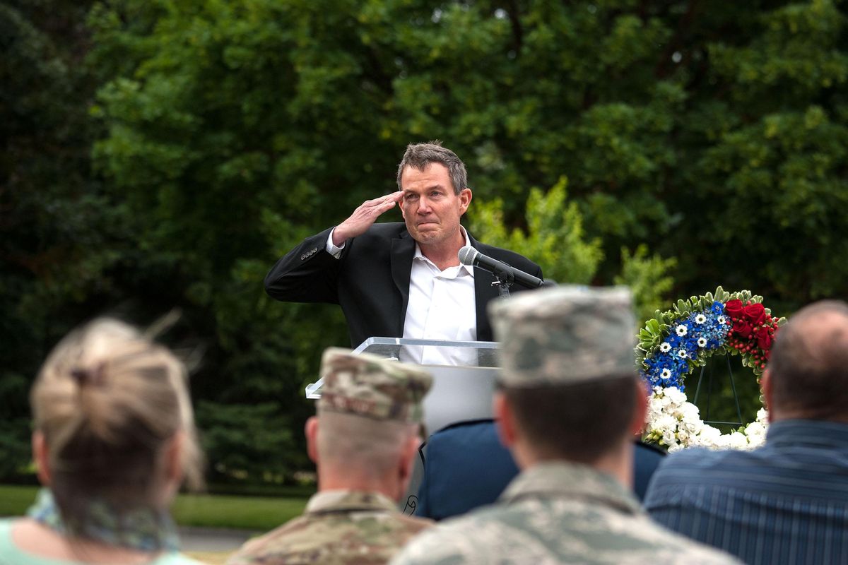 Terry Fossum, Air Force officer and honorary commander of the Washington Air National Guard wing, ends his address with a salute Thursday during  a memorial ceremony marking the 25-year anniversary of the 1994 Mellberg shootings and the B-52 crash at Fairchild Air Force Base (Kathy Plonka / The Spokesman-Review)