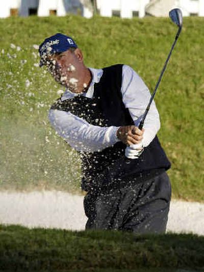 
Leader Jay Haas hits from the sand on the 17th green during the second round of the Tour Championship on Friday in Atlanta.
 (Associated Press / The Spokesman-Review)