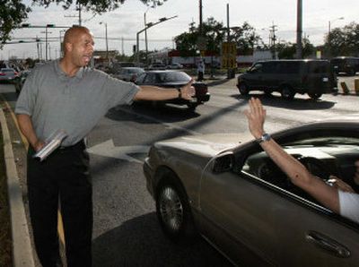 
New Orleans Mayor Ray Nagin slaps the hand of a motorist as he campaigns on Friday. Nagin is facing a host of challengers in today's primary election, including  Lt. Gov. Mitch Landrieu.
 (Associated Press / The Spokesman-Review)