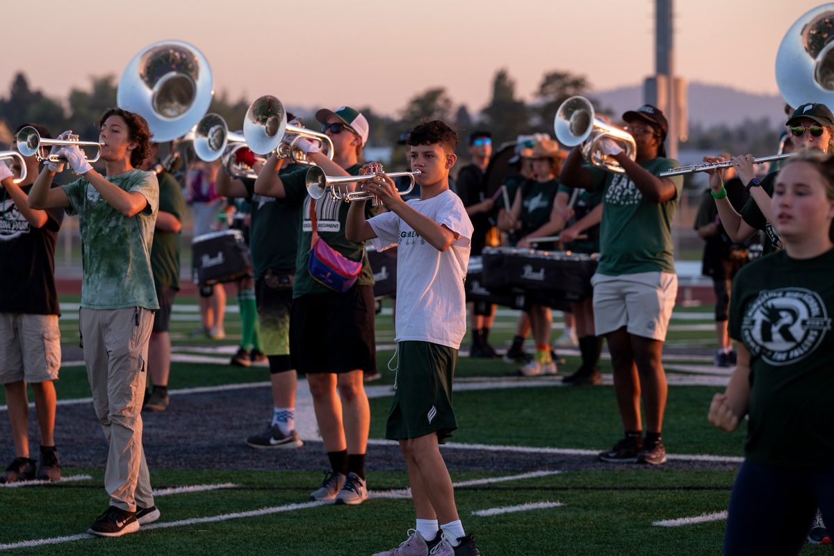 The brass section of the Ridgeline High School marching band, known as the Ridgeline Regiment, works on their program on the school