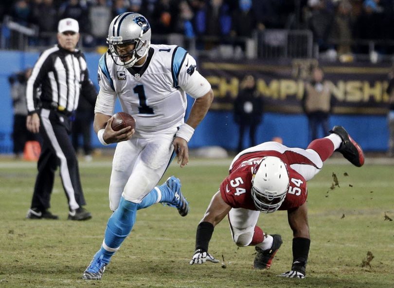 Carolina Panthers' Cam Newton runs past Arizona Cardinals' Kenny Demens for a first down during the second half the NFL football NFC Championship game Sunday, Jan. 24, 2016, in Charlotte, N.C. (AP Photo/Chuck Burton)