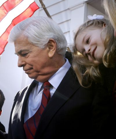 Christina Dodd rests her head on her dad, U.S. Sen. Christopher Dodd, D-Conn., after he announced Wednesday that he will retire.  (Associated Press)