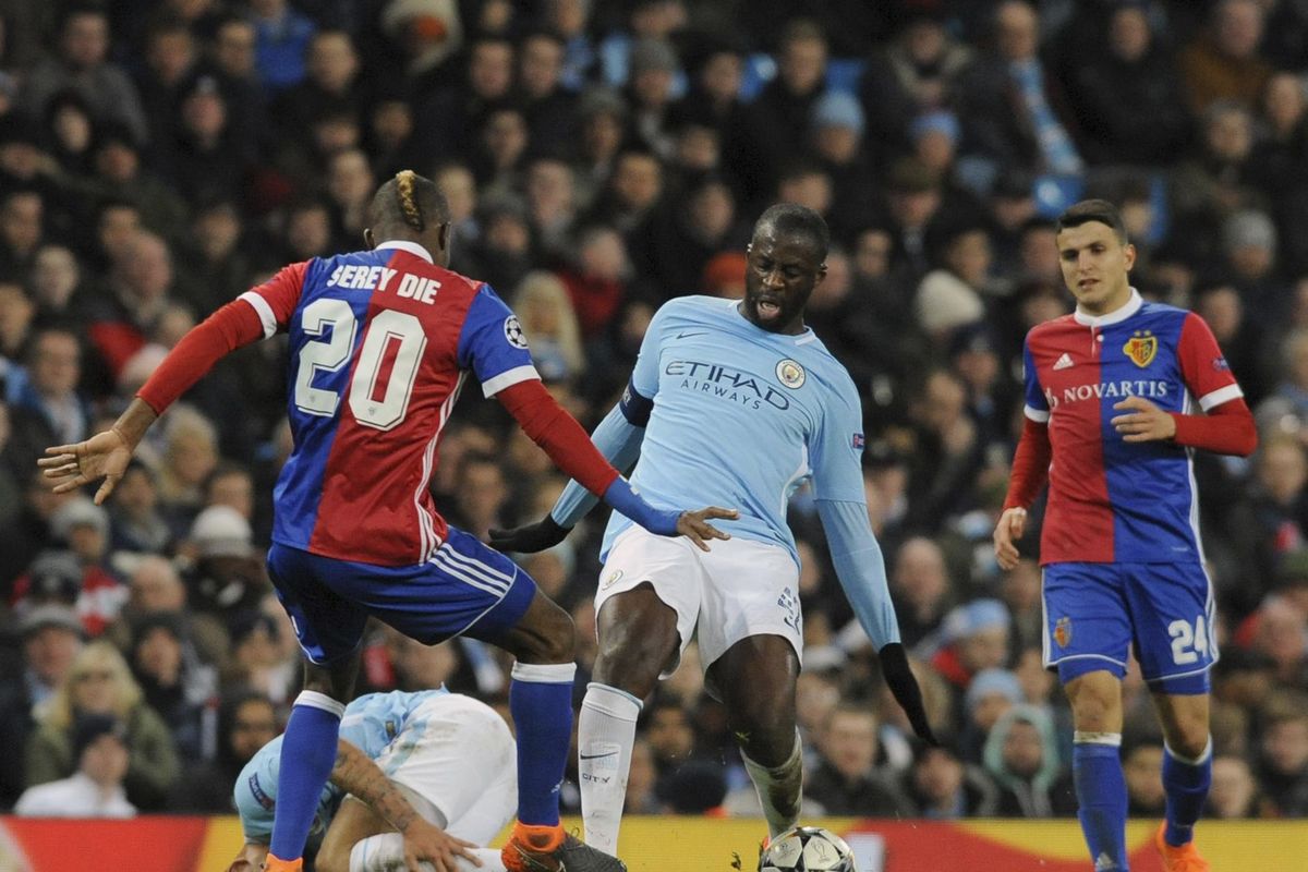 Manchester City’s Yaya Toure, center, challenges for the ball with Basel’s Geoffroy Serey Die, left, during the Champions League, round of 16, second leg soccer match between Manchester City and Basel at the Etihad Stadium in Manchester, England, Wednesday, March 7, 2018. (Rui Vieira / Associated Press)