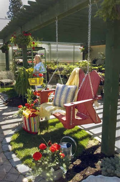 
Marilyn Brink, shopping at Mel's Nursery, passes an Adirondake swing by Uwharrie. 
 (Christopher Anderson/ / The Spokesman-Review)