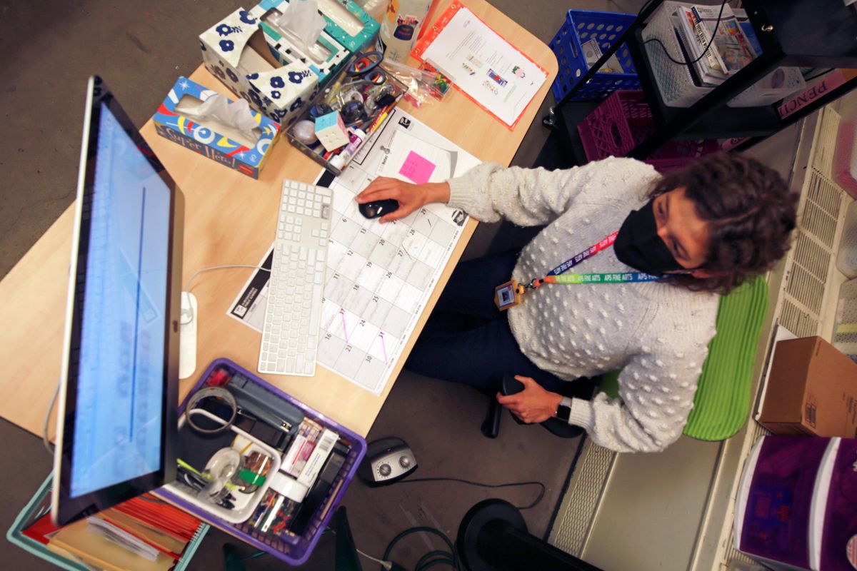 Art teacher Sarah Hager works at a computer in her classroom at Cleveland Middle School on Jan. 23, in Albuquerque, N.M. Public school systems have become an inviting target for ransomware gangs.  (Cedar Attanasio)
