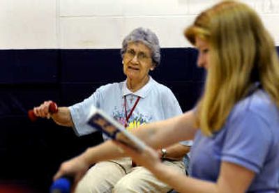 
Yvonne Beldin, 78, works with hand weights as she listens to Kathy Armstrong reading a book of jokes to a class last Wednesday at East Central Community Center. The class meets three times a week, focusing on preventing seniors from suffering bad falls. 
 (Christopher Anderson / The Spokesman-Review)