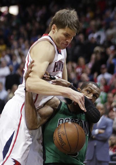 Rajon Rondo, right, injured his knee Friday against the Hawks. (Associated Press)