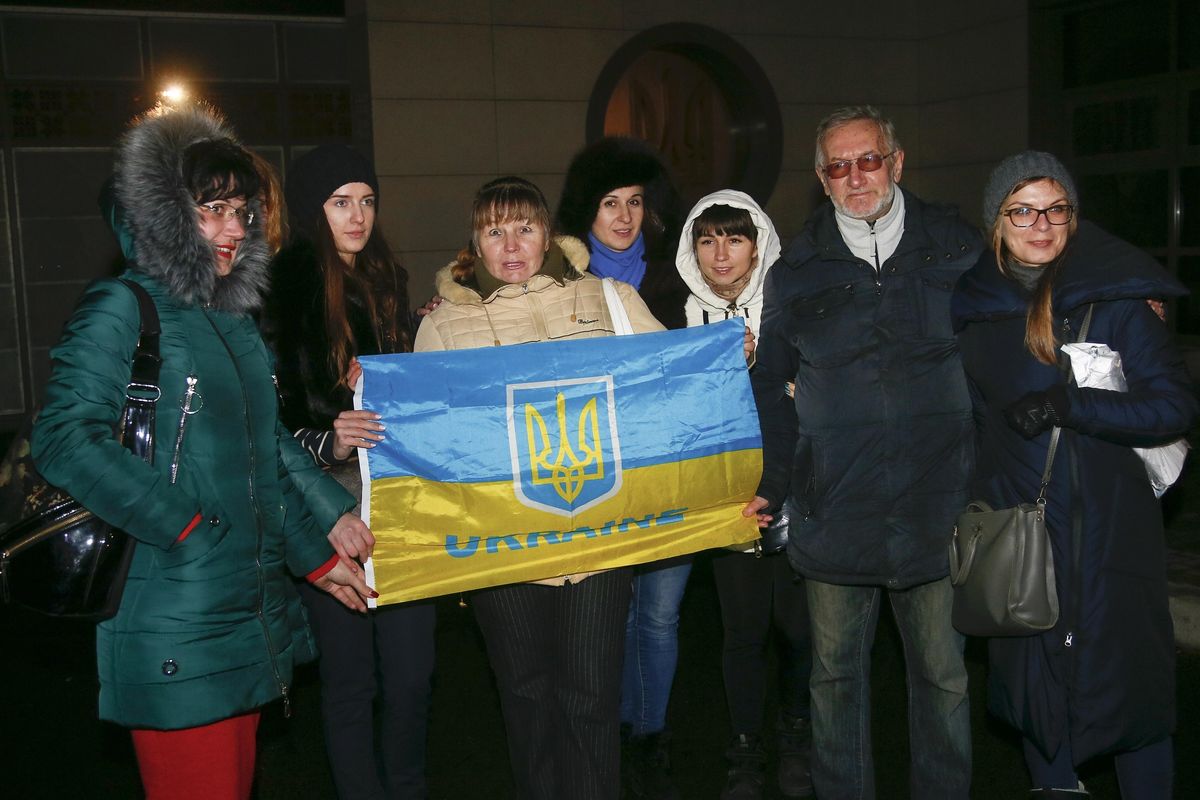 Relatives and friends of the Ukrainian prisoners held by the rebels hold a Ukrainian National flag as they await them at the Kiev airport Wednesday, Dec. 27, 2017. Ukrainian authorities and Russian-backed separatist rebels conducted a massive prisoner exchange Wednesday, the largest such trade of captives since the start of the conflict and a sign of visible progress in the implementation of a 2015 peace deal. (Efrem Lukatsky / Associated Press)