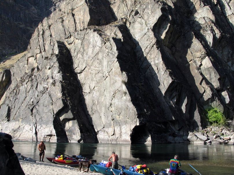 Deep shadows are reflected against a granite wall as rafters unload their boats at Lower Cliffside camp on the Middle Fork of the Salmon River Sept. 19th, 2008. (Staff photo)